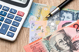 Calculator and Australian bank notes image, illustrating the financial analysis and impacts of the 2018 Federal Budget on individuals and sectors, including insights into Teachers Mutual Bank's adaptation to budget changes for the benefit of educators.