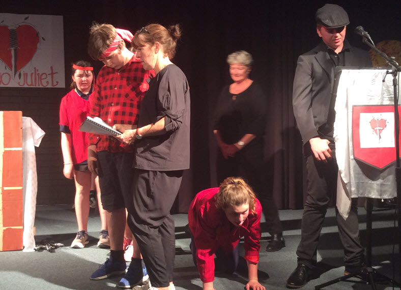 Students with disabilities performing Shakespeare play at school with the help of their teacher