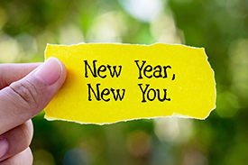A torn piece of paper with 'New Year, New You' written on it, symbolising the fresh start and transformative aspirations often associated with the New Year.