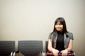 Woman sitting, waiting to be called into an interview for her first teaching job