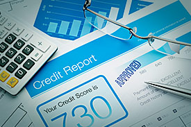 credit report document beside calculator