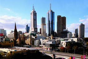 A picture of Melbourne, Victoria showing Flinders Street Station, a bridge crossing the Yarra River, Federation Square and some iconic buildings
