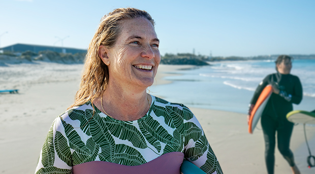 A happy woman enjoys her time at the beach. 