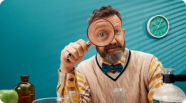 A teacher uses his magnifying glass to inspect his interest rates.